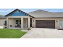 Charming exterior with a covered porch, neat landscaping, and an attached garage at 3055 Wolf Branch Rd, Mount Dora, FL 32757