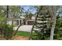 Elegant home with a paved driveway and a spacious three-car attached garage at 3055 Wolf Branch Rd, Mount Dora, FL 32757
