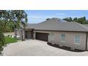 Elegant home with a paved driveway and a spacious three-car attached garage at 3055 Wolf Branch Rd, Mount Dora, FL 32757