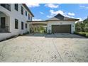 Spacious driveway leading to a modern garage with ample parking and a covered area at 6905 Clayton St, Mount Dora, FL 32757