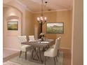 Formal dining room with elegant chandelier, beige walls, and a stylish table set for four at 105 E Blue Water Edge Dr, Eustis, FL 32736