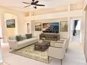 Bright living room featuring neutral walls, a ceiling fan, modern decor and an elegant rug at 105 E Blue Water Edge Dr, Eustis, FL 32736