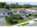 Charming two-story home with a brick driveway, tropical landscaping, and a well-maintained lawn at 1268 Patterson Ter, Lake Mary, FL 32746