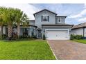 Two-story home boasts a brick driveway, well-manicured lawn, and tasteful landscaping at 1268 Patterson Ter, Lake Mary, FL 32746
