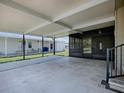 Large carport with an attached screened-in porch and access to the home's side entrance at 1437 Apache Cir, Tavares, FL 32778