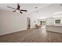 Bright, open-concept living space with modern vinyl flooring and a view to the dining area at 15117 Se 94Th Ter, Summerfield, FL 34491
