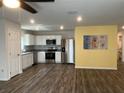 Modern kitchen with stainless steel appliances, white cabinets, and decorative backsplash at 1721 Nebraska Loop, Sumterville, FL 33585