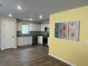 Modern kitchen features stainless steel appliances, white cabinets and an adjacent dining area at 1721 Nebraska Loop, Sumterville, FL 33585