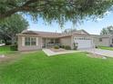 Beautiful single-story home with a well-maintained lawn and an attached two car garage in a neighborhood at 17349 Se 76Th Flintlock Ter, The Villages, FL 32162