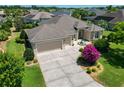 Lovely single-story home featuring a well-manicured lawn, neutral paint scheme, and a spacious driveway and attached garage at 1842 Lake Ridge Dr, The Villages, FL 32162