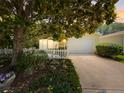 Charming single-story home featuring a well-maintained yard, lovely landscaping, and a welcoming two-car garage at 2102 Estevez Dr, Lady Lake, FL 32159