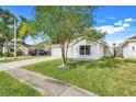 Charming single-story home featuring a well-manicured lawn and two car garage at 2136 Fish Eagle St, Clermont, FL 34714
