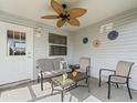 This screened in patio has a ceiling fan and outdoor seating at 2450 Kingstree Pl, The Villages, FL 32162