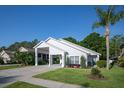 Charming single-story home with a spacious carport and well-manicured lawn with landscaped flower beds at 2539 Caithness Way, Clermont, FL 34714
