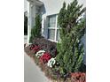Close-up of the landscaping around the home, featuring colorful flowers and lush greenery at 2539 Caithness Way, Clermont, FL 34714