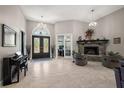Open-concept living room with high ceilings, fireplace, tile floors, and large windows for natural light at 40050 Darlington Ave, Lady Lake, FL 32159