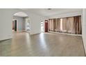 Bright living room with wood floors, an arched doorway, and a red front door at 506 Perkins St, Leesburg, FL 34748