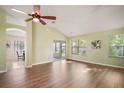 Open floor plan, features new wood flooring, large windows, ceiling fan, and access to the screened in porch at 507 Ventura Ct, The Villages, FL 32159