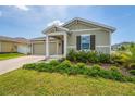 A charming home with a well-manicured lawn and an attached two-car garage at 5354 Travertine St, Mount Dora, FL 32757