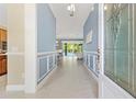 Inviting foyer showcasing detailed trim work, tiled floors, and a glimpse of the pool at 6988 Lawrenceville Way, The Villages, FL 34762