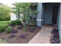 Beautifully landscaped front yard with colorful plants and a brick pathway leading to the entrance at 709 Calabria Way, Howey In The Hills, FL 34737
