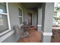 Cozy front porch with seating, offering a welcoming entrance to the home at 709 Calabria Way, Howey In The Hills, FL 34737