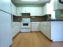 Well-lit kitchen featuring a full suite of white appliances and ample cabinet space at 8431 Sw 93Rd Place # F, Ocala, FL 34481