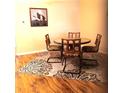 Cozy dining area with a round table, four chairs, and a decorative rug under a goose artwork at 8431 Sw 93Rd Place # F, Ocala, FL 34481