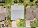 Overhead view of house showing the roof, driveway, and landscaping at 951 Chapman Loop, The Villages, FL 32162