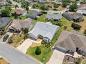 Aerial view of the home and neighborhood showcasing the well-maintained landscaping and community at 951 Chapman Loop, The Villages, FL 32162