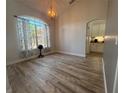 Bright dining area features wood floors, arched window and stylish chandelier at 11301 Via Mari Cae Ct, Clermont, FL 34711