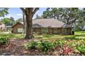 Charming single-story brick home featuring a lush front lawn and mature trees at 12104 Elbert St, Clermont, FL 34711