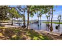 Picturesque waterfront view with a private dock, sandy beach area, and tranquil waters, perfect for recreation at 12104 Elbert St, Clermont, FL 34711