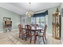 Elegant dining room featuring a chandelier, a large window, and a classic dining set with seating for six at 1350 Mosswood Dr, Leesburg, FL 34748