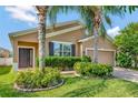 Lovely single-story home with meticulously landscaped yard, beautiful palm trees, and brick driveway for added charm at 15322 Veramonte Way, Orlando, FL 32828