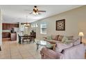 Inviting living room with neutral tones, tile flooring, and comfortable seating, perfect for relaxation and entertaining at 15322 Veramonte Way, Orlando, FL 32828