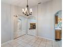 Open-concept dining area with tile floors and arched doorways leading to the living room and kitchen, creating a flow at 1663 Markel Dr. Dr, Winter Garden, FL 34787