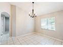 Dining room featuring tile flooring, a chandelier, and a sunlit window providing natural light at 1663 Markel Dr. Dr, Winter Garden, FL 34787