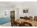 Formal dining room with wooden table, decorative chandelier, and classic design at 2112 Saint Ives Ct, Clermont, FL 34711