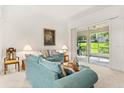 Bright living room featuring neutral colors, comfortable seating, and sliding glass doors to the lanai at 2112 Saint Ives Ct, Clermont, FL 34711