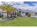 Charming single Gathering home featuring a well manicured lawn and beautiful front yard landscaping at 2129 Landrea Loop, The Villages, FL 32163
