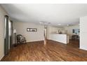 Spacious living room with hardwood floors, natural light, ceiling fans, and an open floor plan at 2296 Whisper St, The Villages, FL 32162
