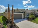 Inviting single-Gathering home with a spacious driveway, two-car garage, and professionally landscaped front yard at 2675 Ridgetop Ln, Clermont, FL 34711