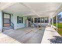 A covered carport and entry with space for sitting adds an outdoor living element to the home at 3026 Myakka River Rd, Tavares, FL 32778