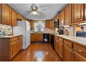 Well-appointed kitchen with wood cabinets, appliances, a tiled backsplash and hardwood floors at 3026 Myakka River Rd, Tavares, FL 32778