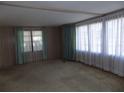 Bright living room featuring large windows offering plenty of natural light at 323 Hawthorne Blvd, Leesburg, FL 34748