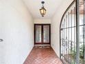 View of the front entryway with a decorative metal door and tiled floor at 33620 Picciola Dr, Fruitland Park, FL 34731