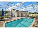 Relaxing pool area with a screened enclosure, brick patio, and plenty of space for outdoor lounging at 342 Mccormick Ln, The Villages, FL 32162