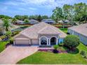 An aerial view showcases the home's manicured lawn and landscaping, surrounded by mature trees at 3775 Brantley Place Cir, Apopka, FL 32703