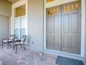 Inviting front porch with seating and elegant double doors, perfect for relaxing at 3775 Brantley Place Cir, Apopka, FL 32703